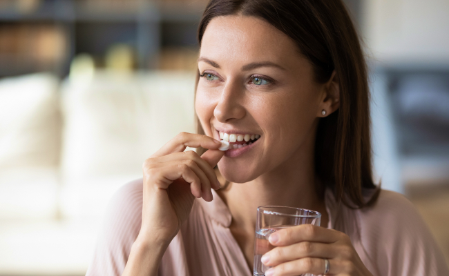 woman taking a pill