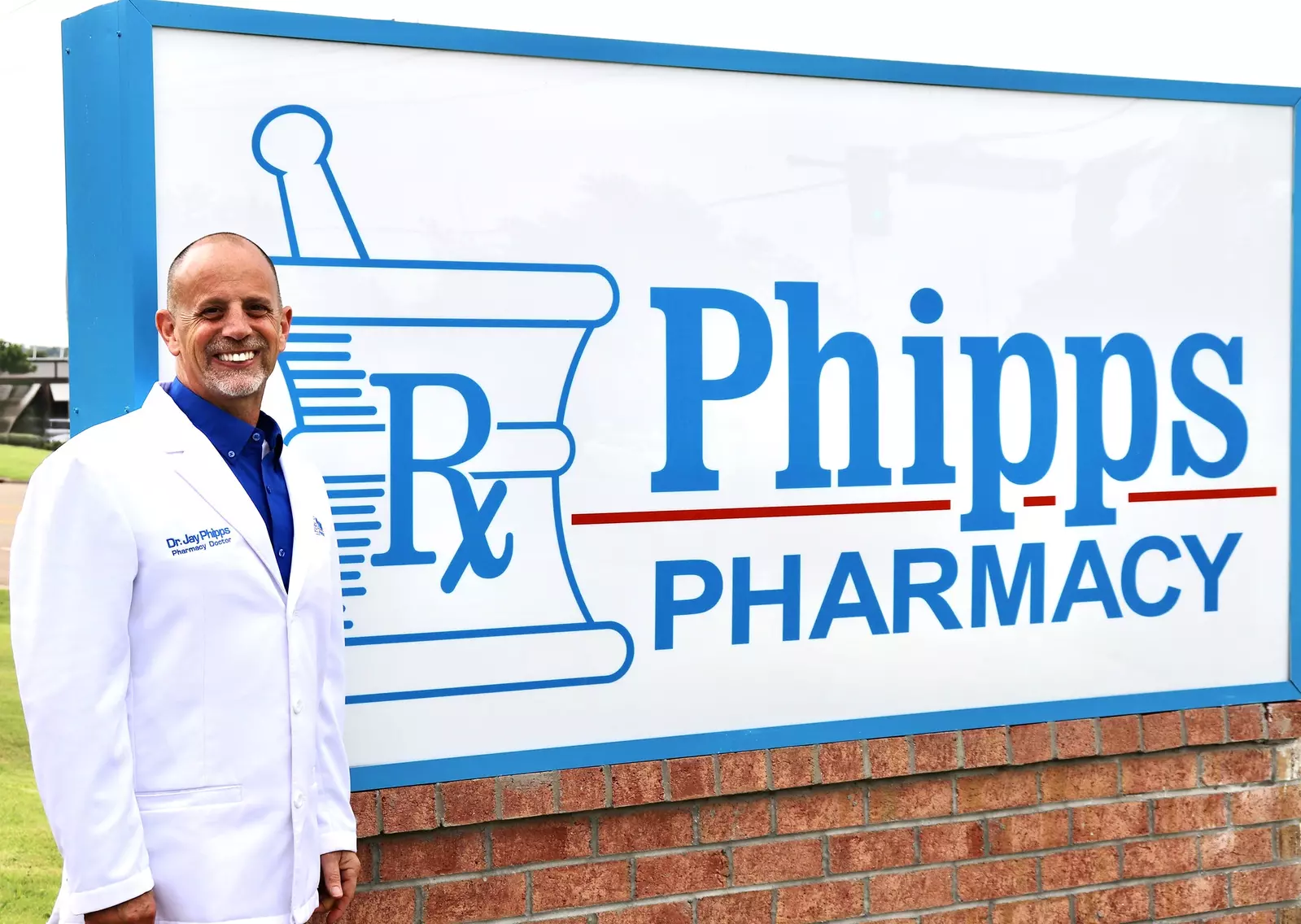 Jay in front of Phipps Pharmacy sign