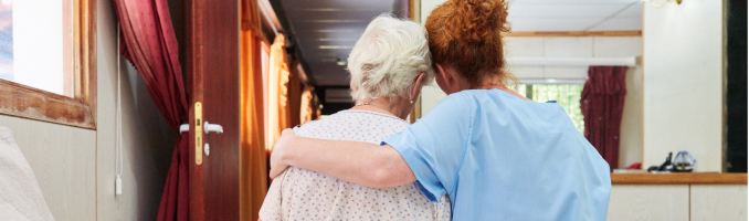 hospice nurse with arm over patient's shoulder