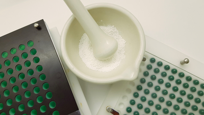 compounding medication into pills using mortar and pestle
