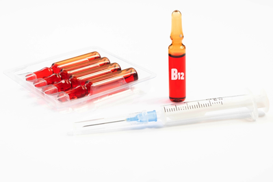 vials of vitamin b12 and syringe