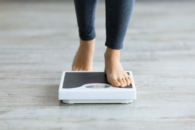 woman's feet stepping onto scale