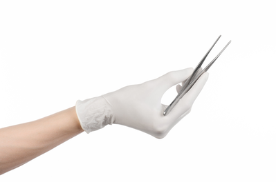 gloved handing holding tweezers