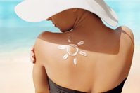 sunscreen in the shape of a sun on woman's back