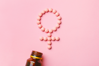 pink pills in shape of female gender symbol