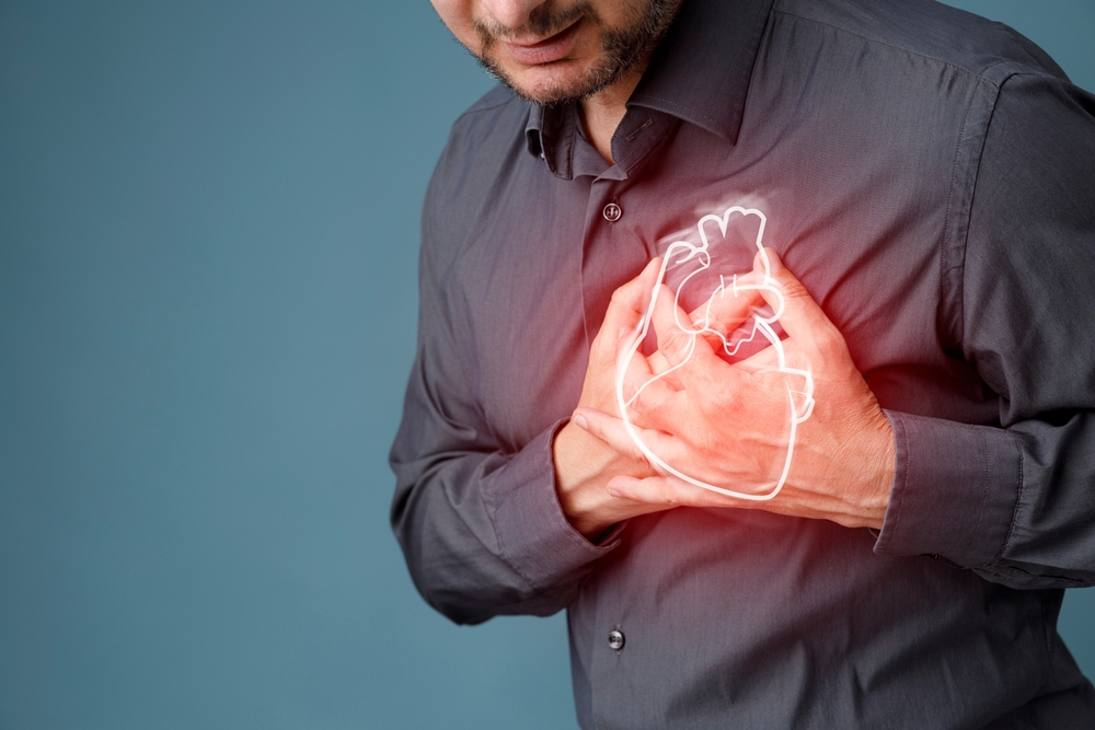 man holding chest with illustration of heart over his hands