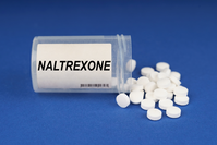 white pills spilling from bottle labeled NALTREXONE